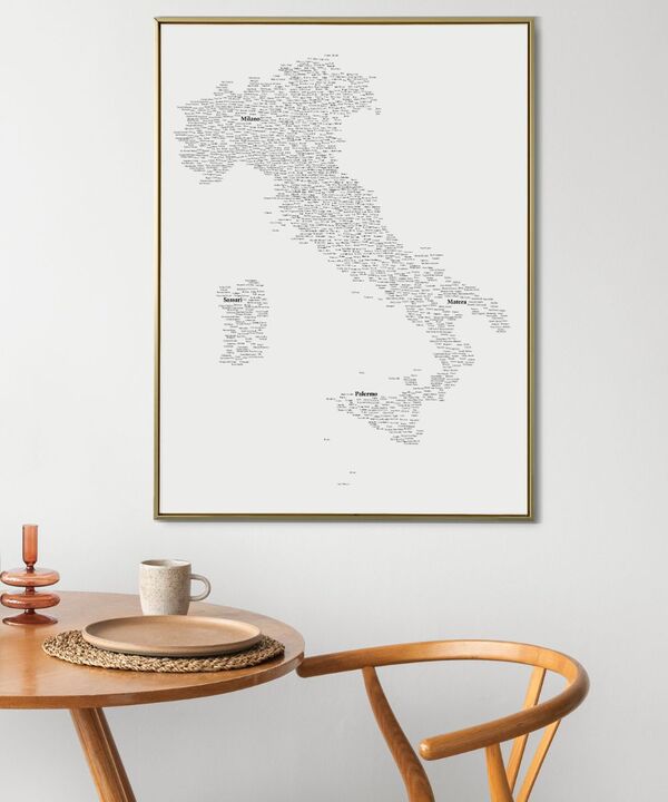 Et lodret typografisk kort over Italien hænger over et spisebord